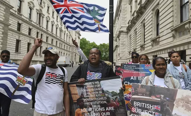 People demonstrate outside the Foreign Office in London, Thursday, May 22, 2025, after a British court blocked the U.K. from transferring sovereignty over the Chagos Islands to Mauritius hours before the agreement was due to be signed. (AP Photo/Thomas Krych)