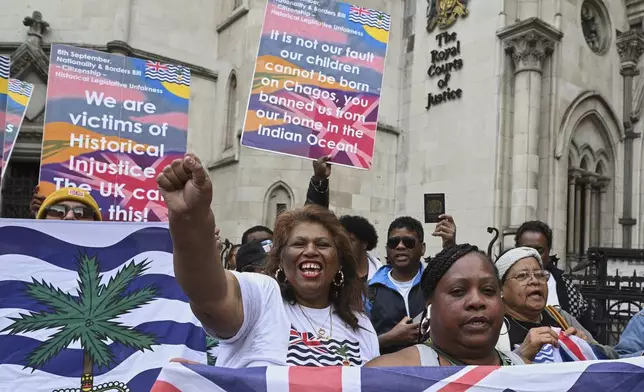 People demonstrate outside the High Court in London, Thursday, May 22, 2025, after a British court blocked the U.K. from transferring sovereignty over the Chagos Islands to Mauritius hours before the agreement was due to be signed. (AP Photo/Thomas Krych)