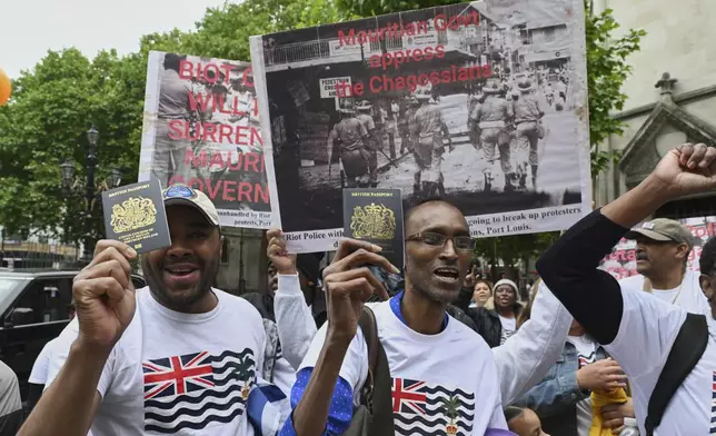 People demonstrate outside the High Court in London, Thursday, May 22, 2025, after a British court blocked the U.K. from transferring sovereignty over the Chagos Islands to Mauritius hours before the agreement was due to be signed. (AP Photo/Thomas Krych)
