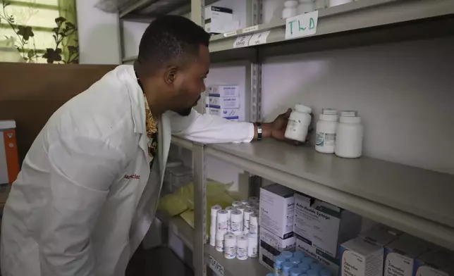Dr. Execuel Laguerre checks inventory in the room where medications are stored at the New Hope Hospital, in Plaine-du-Nord, Haiti, Wednesday, May 21, 2025. (AP Photo/Patrice Noel)