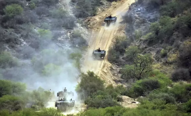 In this photo released by the Inter Services Public Relations, Army tanks roll down during a military exercises in Tilla Field Firing Range, in the Jhelum district, Pakistan, Thursday, May 1, 2025. (Inter Services Public Relations via AP)