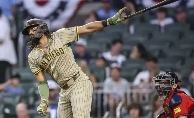 San Diego Padres' Fernando Tatis Jr. hits a double in the sixth inning of a baseball game against the Atlanta Braves, Friday, May 23, 2025, in Atlanta. (AP Photo/Colin Hubbard)