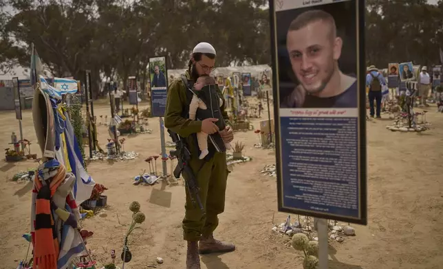 FILE - An Israeli soldier walks at the site of Oct. 7, 2023, attack by Hamas militants at the Nova music festival near Kibbutz Reim, southern Israel, April 30, 2025. (AP Photo/Ohad Zwigenberg, File)