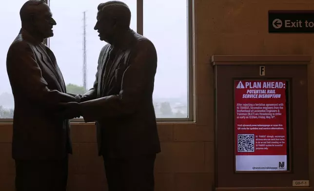 An electronic display advises commuters of potential NJ Transit service disruptions at the Secaucus Junction station in Secaucus, N.J., Wednesday, May 14, 2025. (AP Photo/Seth Wenig)