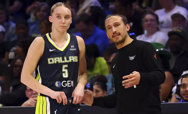 Dallas Wings guard Paige Bueckers (5) talks with head coach Chris Koclanes, right, in the first half of a WNBA basketball game against the Minnesota Lynx, Friday, May 16, 2020, in Arlington, Texas. (AP Photo/Richard W. Rodriguez)
