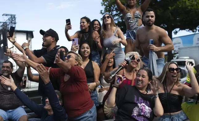 Lady Gaga fans dance outside the Copacabana Palace hotel where the pop diva is staying, in Rio de Janeiro, Thursday, May 01, 2025. Lady Gaga is in Rio to give a free concert, that will be held on Saturday, at Copacabana Beach. (AP Photo/Bruna Prado)