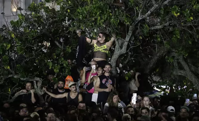 Fans watch Lady Gaga rehearse a day ahead of her free concert, on Copacabana beach, in Rio de Janeiro, Friday, May 2, 2025. (AP Photo/Bruna Prado)