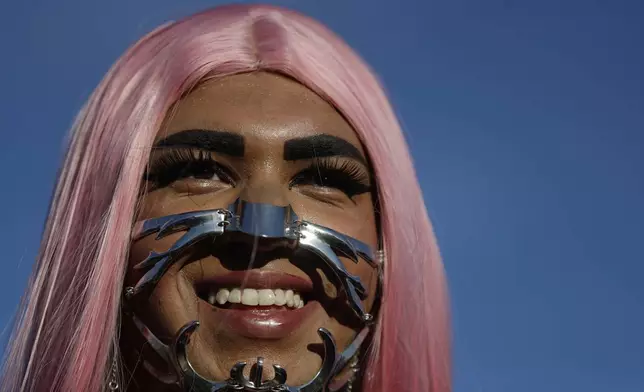 A fan dons a punk mechanical face mask while waiting for the start of Lady Gaga's free concert on Copacabana beach in Rio de Janeiro, Saturday, May 3, 2025. (AP Photo/Bruna Prado)
