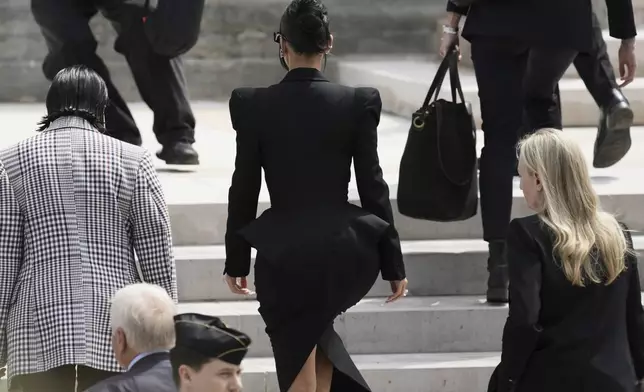 Kim Kardashian, center, walks up the steps of the palace of justice as she arrives to testify regarding a robbery of millions of dollars in jewels from her Paris hotel room in 2016, in Paris, Tuesday, May 13, 2025. (AP Photo/Aurelien Morissard)