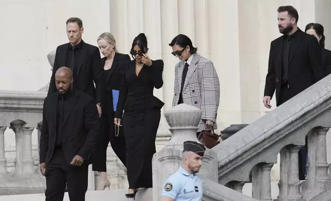 Kim Kardashian, center left, accompanied by her mother Kris Jenner, center right, leaves the justice palace after testifying, regarding a robbery of millions of dollars in jewels from her Paris hotel room in 2016, in Paris, Tuesday, May 13, 2025. (AP Photo/Aurelien Morissard)