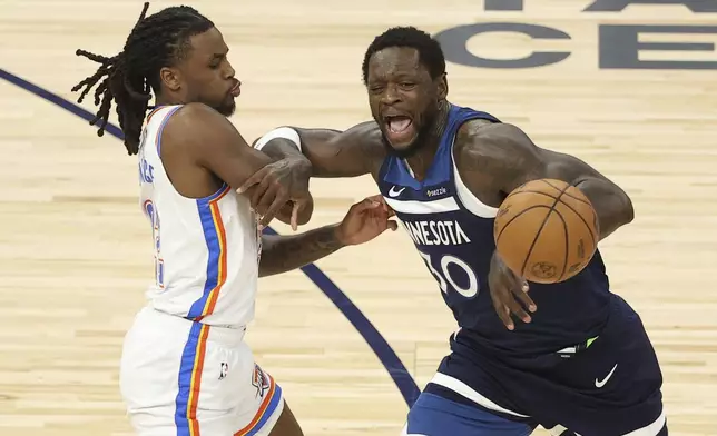 Minnesota Timberwolves forward Julius Randle (30) loses control of the ball while defended by Oklahoma City Thunder guard Cason Wallace (22) during the first half of Game 3 of the Western Conference finals of the NBA basketball playoffs, Saturday, May 24, 2025, in Minneapolis. (AP Photo/Matt Krohn)
