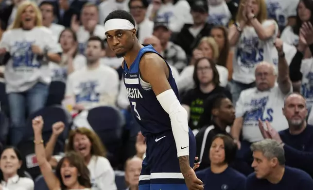 Minnesota Timberwolves forward Jaden McDaniels (3) reacts after making a 3-pointer against Oklahoma City Thunder during the second half of Game 3 of the Western Conference finals of the NBA basketball playoffs, Saturday, May 24, 2025, in Minneapolis. (AP Photo/Abbie Parr)