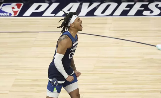 Minnesota Timberwolves guard Terrence Shannon Jr. (00) celebrates during the first half of Game 3 of the Western Conference finals of the NBA basketball playoffs against the Oklahoma City Thunder, Saturday, May 24, 2025, in Minneapolis. (AP Photo/Matt Krohn)