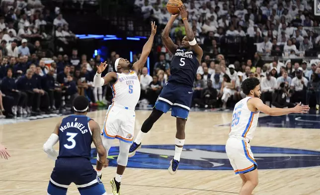 Minnesota Timberwolves guard Anthony Edwards, center right, shoots against Oklahoma City Thunder guard Luguentz Dort, center left, during the first half of Game 3 of the Western Conference finals of the NBA basketball playoffs, Saturday, May 24, 2025, in Minneapolis. (AP Photo/Abbie Parr)