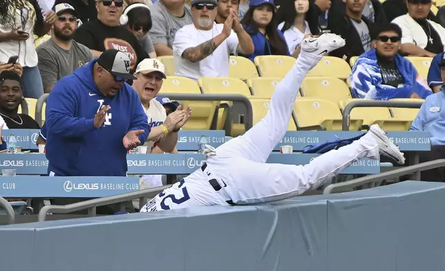 Los Angeles Dodgers outfielder Michael Conforto (23) makes a catch in foul territory against the Miami Marlins during the first inning of a baseball game Wednesday, April 30, 2025, in Los Angeles. (AP Photo/Wally Skalij)