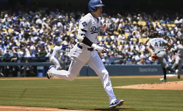 Los Angeles Dodgers' Shohei Ohtani (17) runs up the first base line while grounding into a force play against the Miami Marlins during in the third inning of a baseball game, Wednesday, April 30, 2025, in Los Angeles. (AP Photo/Wally Skalij)
