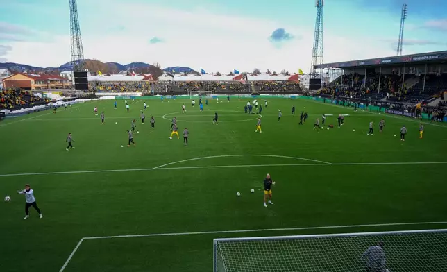 Players warm up before the first leg quarter-final soccer match of the UEFA Europa League between Bodø/Glimt and Lazio at Aspmyra Stadium in Bodø, Norway, Thursday, March 13, 2025. (Lise Åserud/NTB Scanpix via AP)