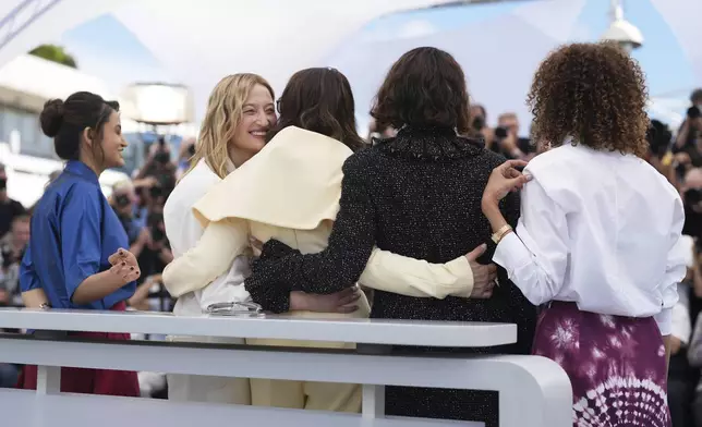Jury president Juliette Binoche, centre, and jury members Payal Kapadia, Alba Rohrwacher, Halle Berry and Leila Slimani pose for photographers at the jury photo call at the 78th international film festival, Cannes, southern France, Tuesday, May 13, 2025. (AP Photo/Natacha Pisarenko)