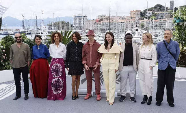 Jury president Juliette Binoche, fourth from right, and jury members Carlos Reygadas, from left, Payal Kapadia, Leila Slimani, Halle Berry, Jeremy Strong, Dieudo Hamadi, Alba Rohrwacher, and Hong Sang-soo pose for photographers at the jury photo call at the 78th international film festival, Cannes, southern France, Tuesday, May 13, 2025. (Photo by Joel C Ryan/Invision/AP)