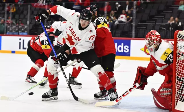 Canada's Will Cuylle, front in action during the IIHF Ice Hockey World Championship group A match between Canada and Austria in Stockholm, Sweden, Thursday, May 15, 2025. (Anders Wiklund/TT News Agency via AP)