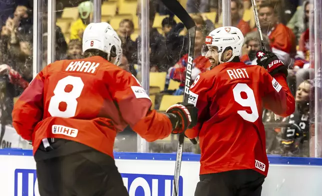 Switzerland's scorer Damien Riat, right, and his teammate Simon Knak, left, celebrate the opening goal during the IIHF 2025 World Championship group B match between Switzerland and Germany in Herning, Denmark, Thursday, May 15, 2025. (Salvatore Di Nolfi/Keystone via AP)