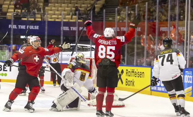 Switzerland's Sven Andrighetto, second right, celebrates after scoring his side's third goal during the IIHF 2025 World Championship group B match between Switzerland and Germany in Herning, Denmark, Thursday, May 15, 2025. (Salvatore Di Nolfi/Keystone via AP)