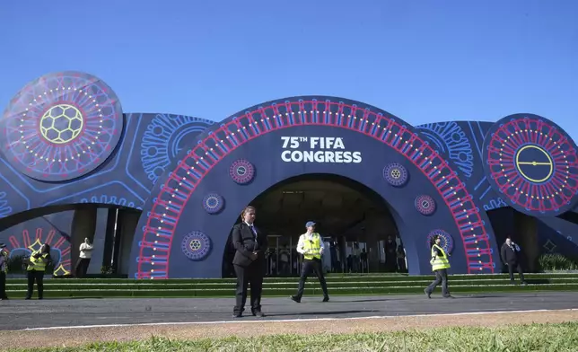 Guards stand at the entrance to the Conmebol Convention Center which is hosting the FIFA Congress in Luque, Paraguay, Thursday, May 15, 2025. (AP Photo/Fernando Calistro)