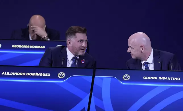 Conmebol President Alejandro Dominguez, left, talks to FIFA President Gianni Infantino during FIFA's 75th Congress at the Conmebol Convention Center in Luque, Paraguay, Thursday, May 15, 2025. (AP Photo/Fernando Calistro)