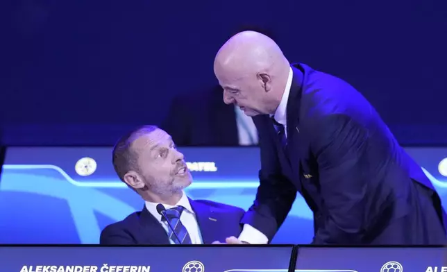 FIFA President Gianni Infantino, right, talks to UEFA President Aleksander Ceferin during the FIFA 75th Congress at the Conmebol Convention Center in Luque, Paraguay, Thursday, May 15, 2025. (AP Photo/Fernando Calistro)
