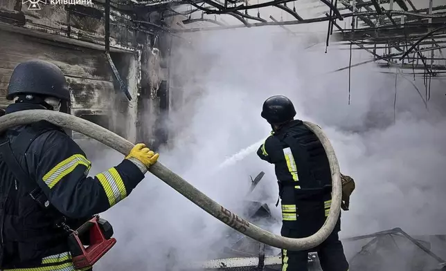 In this photo provided by the Ukrainian Emergency Service, firefighters put out the fire following Russia's drone attack in the Kyiv region, Ukraine, Sunday, May 18, 2025. (Ukrainian Emergency Service via AP)