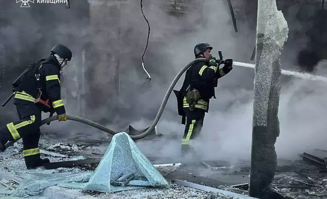 In this photo provided by the Ukrainian Emergency Service, firefighters put out the fire following Russia's drone attack in the Kyiv region, Ukraine, Sunday, May 18, 2025. (Ukrainian Emergency Service via AP)