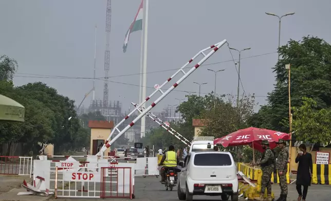 Vehicles pass through a checkpoint at Wagah, a joint border crossing point on the Pakistan and India border, near Lahore, Pakistan, Thursday, May 1, 2025.(AP Photo/K.M. Chaudary)