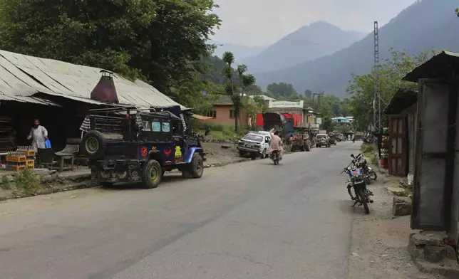 A motorcyclist drives through an empty market at a tourists point in Karen, in the Neelum Valley near on the Line of Control, the de facto border that divides the disputed region of Kashmir, some 93 kilometres (58 miles) from Muzaffarabad, the capital of Pakistan controlled Kashmir, Thursday, May 1, 2025. (AP Photo/Ishfaq Hussain)