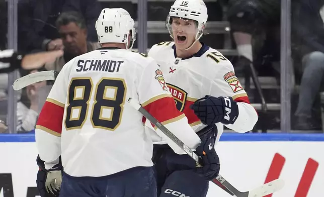 Florida Panthers center Anton Lundell (15) celebrates affter his goal with teammate Nate Schmidt (88) during the second period of Game 7 of a second-round NHL hockey playoff series against the Toronto Maple Leafsin Toronto, Sunday, May 18, 2025. (Frank Gunn/The Canadian Press via AP)