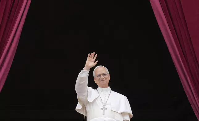Pope Leo XIV appears on the central balcony of St. Peter's Basilica at the Vatican to bless the crowd below on May 11, 2025. (AP Photo/Gregorio Borgia)