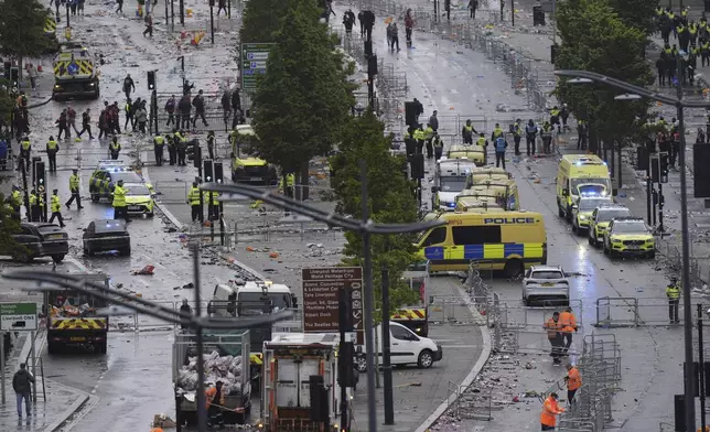 Police and emergency personnel deal with an incident on Water Street near the Liver Building in Liverpool after a car collided with pedestrians during the Premier League winners parade, in Liverpool, England, Monday May 26, 2025. (Danny Lawson/PA via AP)