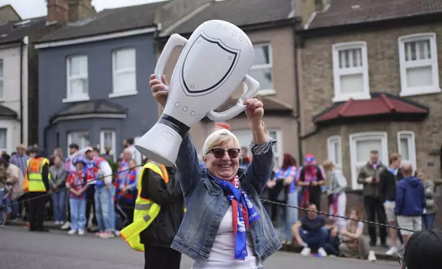 Crystal Palace fans arriving before the FA Cup winners parade in London, Monday, May 26, 2025. (Yui Mok/PA via AP)
