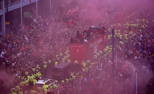 The open-top buses arrives close to Liverpool Waterfront during the Premier League winners parade in Liverpool, England, Monday May 26, 2025. (Owen Humphreys/PA via AP)