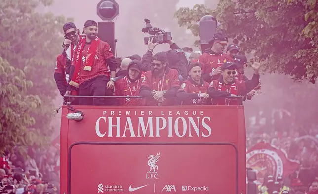 Liverpool players on the team bus during the English Premier League winners parade in Liverpool, England, Monday, May 26, 2025. (Peter Byrne/PA via AP)