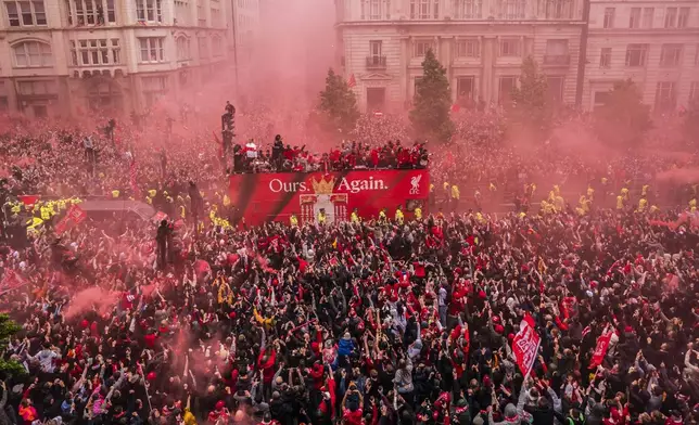 Crowds greet the Liverpool soccer team during their Premier League winners parade in Liverpool, England, Monday, May 26, 2025. (Owen Humphreys/PA via AP)