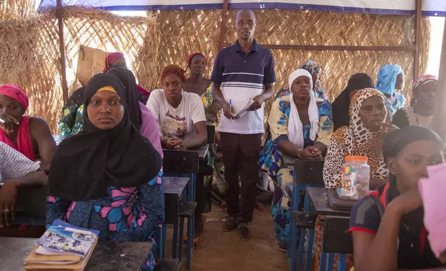 Sidi Yaya Sangare, center, teaches Bambara in a makeshift classroom in the village of Mountougoula, Mali, April 7, 2025. (AP Photo/Saydou Camara)