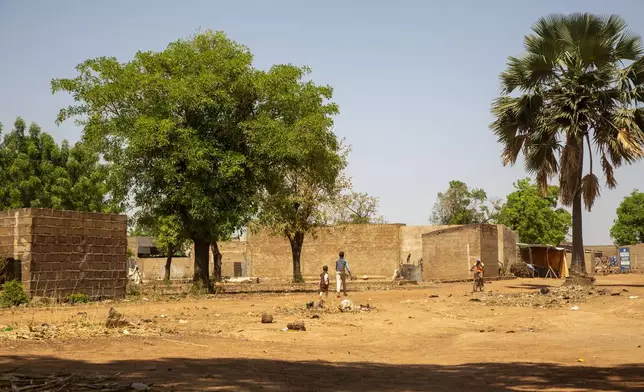 People walk through the village of Mountougoula, Mali, April 7, 2025. (AP Photo/Saydou Camara)