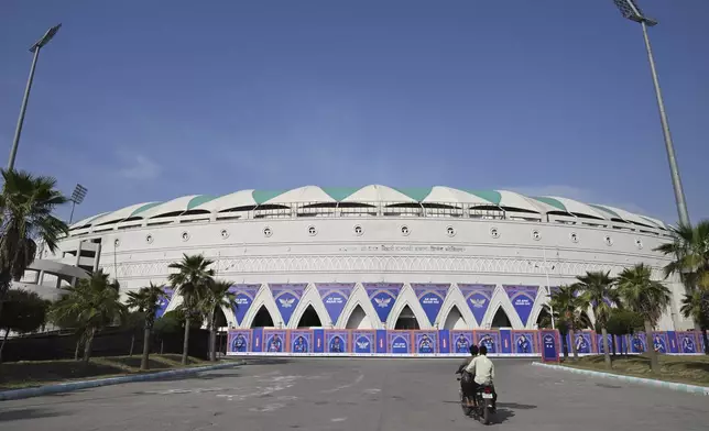 Workers ride on a motorcycle inside the premises of closed Atal Bihari Vajpayee Ekana Cricket Stadium after organizers suspended the Indian Premier League for one week following the escalating military tensions with Pakistan, in Lucknow, India, Friday, May 9, 2025. (AP Photo)