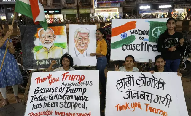 Students of an art school and their teacher carry hand-drawn portraits of Indian Prime Minister Narendra Modi and US President Donald Trump as they celebrate the ceasefire between India and Pakistan, in Mumbai, India, Saturday, May 10, 2025. (AP Photo/Rajanish Kakade)