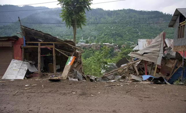 An Indian flag lies in front of a damaged shop following overnight shelling from Pakistan at Gingal village in Uri district, north of Srinagar in Indian controlled Kashmir, Friday, May 9, 2025. (AP Photo/Dar Yasin)