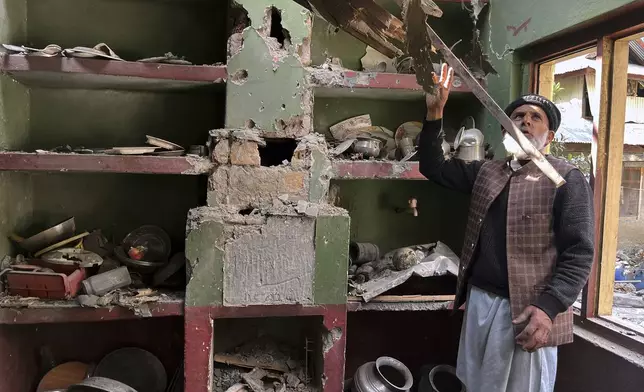 A Kashmiri villager examines damages to his house caused by overnight Indian shelling, in Shah Kot, in Neelum Vallery, a district of Pakistan's administered Kashmir, Saturday, May 10, 2025. (AP Photo/M.D. Mughal)