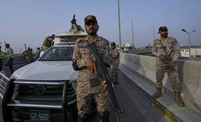 A paramilitary soldier stand alert on a road near Karachi port following raising military tension between Pakistan and India, in Karachi, Pakistan, Friday, May 9, 2025. (AP Photo/Fareed Khan)