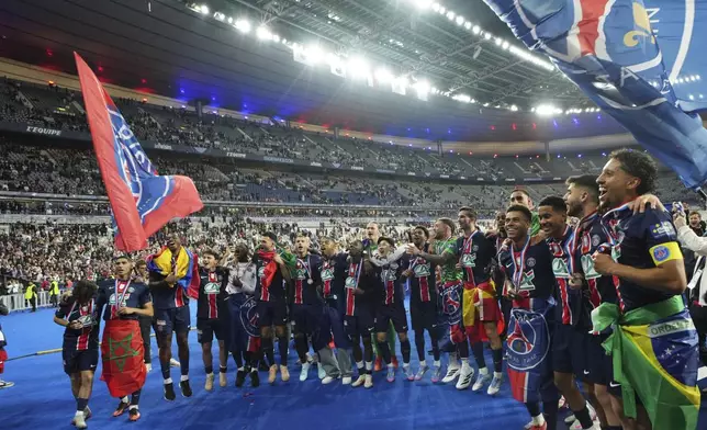 PSG's players celebrate after winning the French Cup soccer final between Paris Saint-Germain and Reims at the Stade de France stadium in Saint-Denis, outside Paris, Saturday, May 24, 2025. (AP Photo/Aurelien Morissard)