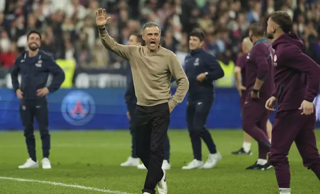 PSG's head coach Luis Enrique, center, celebrates at the end of the French Cup soccer final between Paris Saint-Germain and Reims at the Stade de France stadium in Saint-Denis, outside Paris, Saturday, May 24, 2025. (AP Photo/Aurelien Morissard)