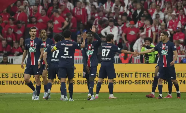 PSG's players celebrate their side second goal scored by Bradley Barcola during the French Cup soccer final between Paris Saint-Germain and Reims at the Stade de France stadium in Saint-Denis, outside Paris, Saturday, May 24, 2025. (AP Photo/Aurelien Morissard)